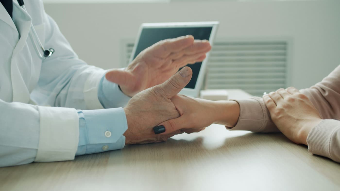 Medical administrator verifying patient insurance eligibility on computer
